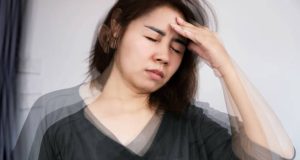 Woman experiencing dizziness and fatigue from hypoglycaemia