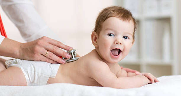 Doctor examining baby for flat head syndrome treatment