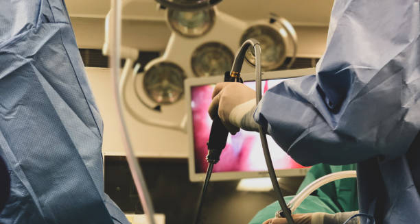 Surgeons performing minimally invasive procedure with endoscopic equipment