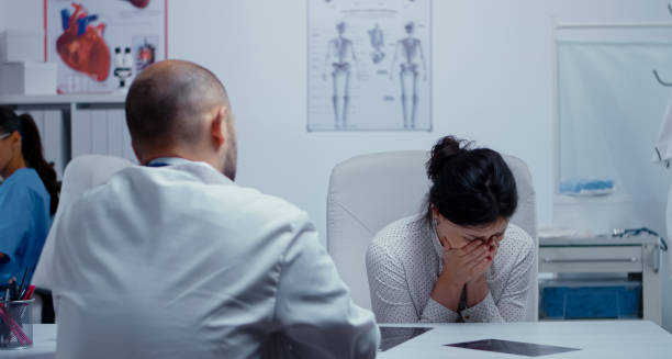 Woman covering face during medical consultation for anxiety treatment