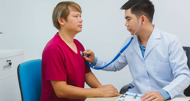 Doctor examining male patient during gonorrhoea treatment