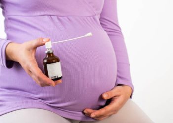 Pregnant woman holding medication for Group B Strep treatment