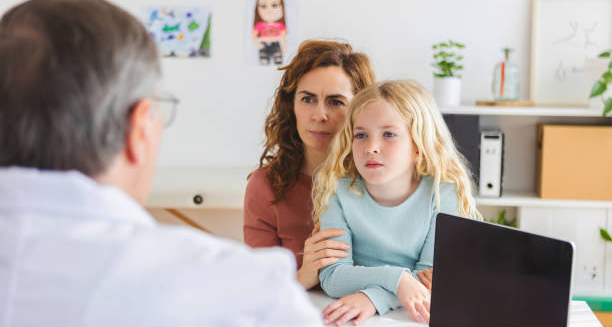 Child receiving medical advice for growing pains