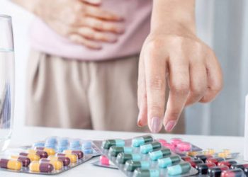 Person selecting medication to treat heartburn symptoms