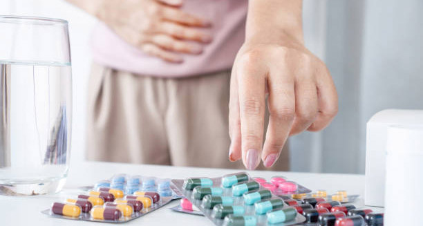 Person selecting medication to treat heartburn symptoms