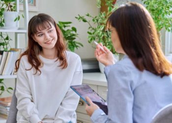 Smiling woman in therapy session receiving treatment for hoarding disorder