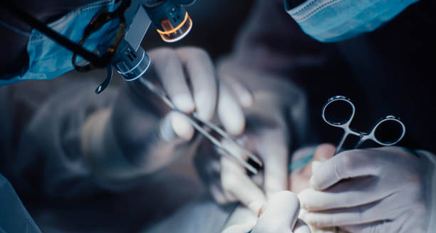 Surgeons performing a medical procedure under magnification lights