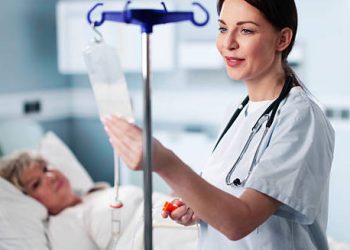 Nurse administering IV treatment to patient with Isovaleric Acidaemia