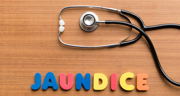Stethoscope on wooden background with colourful letters spelling ‘Jaundice’